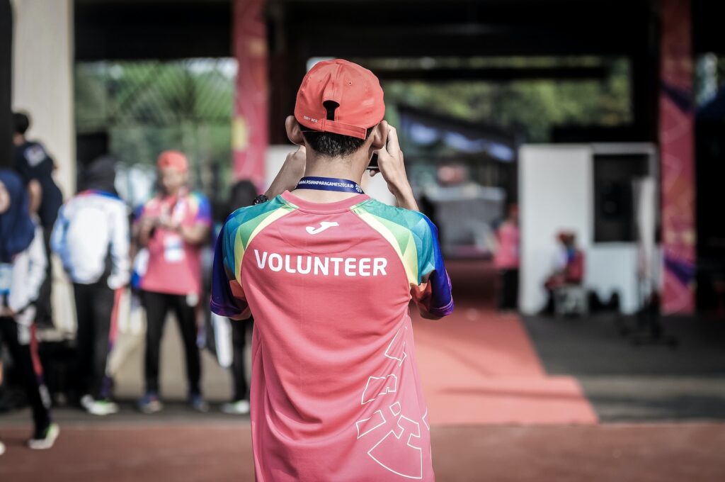 Volunteers person standing wearing red shirt